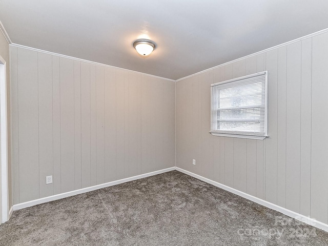 unfurnished room with dark carpet