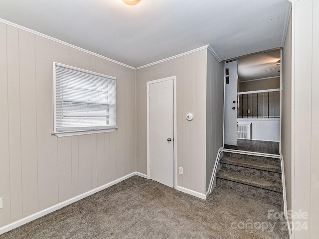 carpeted spare room featuring ornamental molding