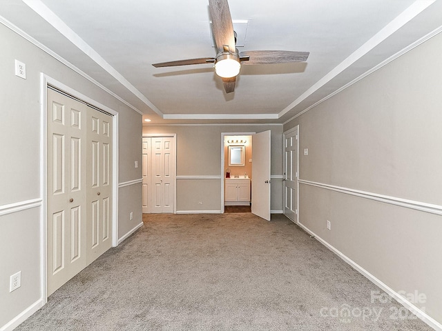 unfurnished bedroom featuring connected bathroom, ceiling fan, light colored carpet, and ornamental molding