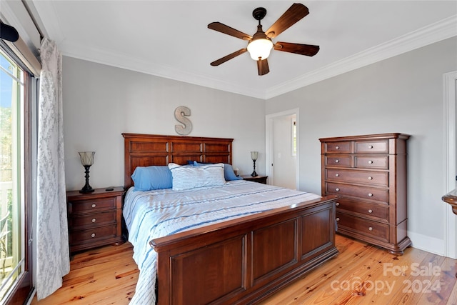 bedroom featuring ceiling fan, light hardwood / wood-style flooring, and crown molding