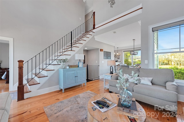 living room featuring light hardwood / wood-style floors and crown molding