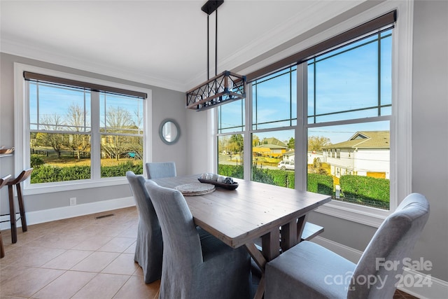 tiled dining space featuring ornamental molding