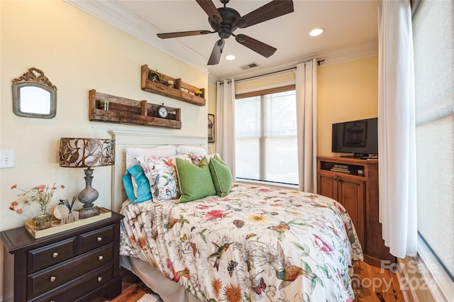 bedroom featuring wood-type flooring, ceiling fan, and crown molding