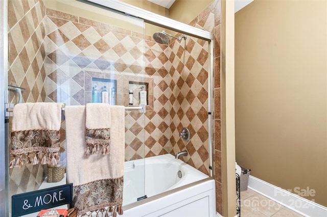 bathroom featuring tile patterned flooring and shower / bath combination with glass door