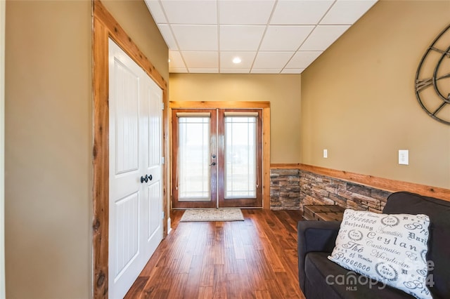 interior space with hardwood / wood-style flooring, a paneled ceiling, and french doors