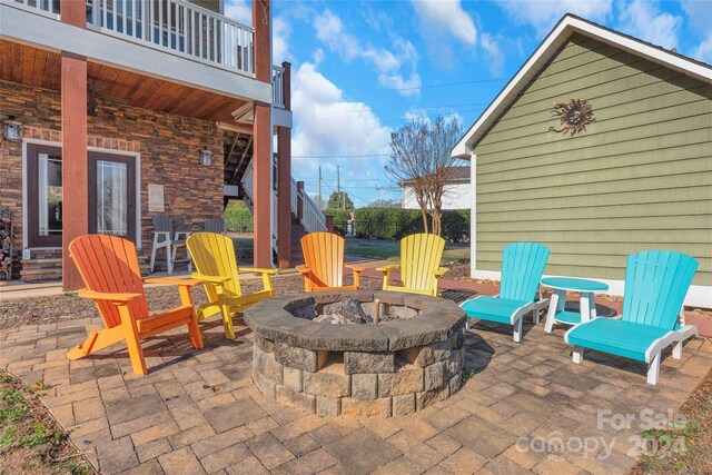 view of patio / terrace featuring a balcony and a fire pit