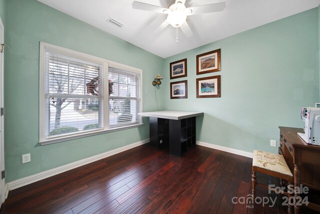 office space featuring ceiling fan and dark hardwood / wood-style flooring