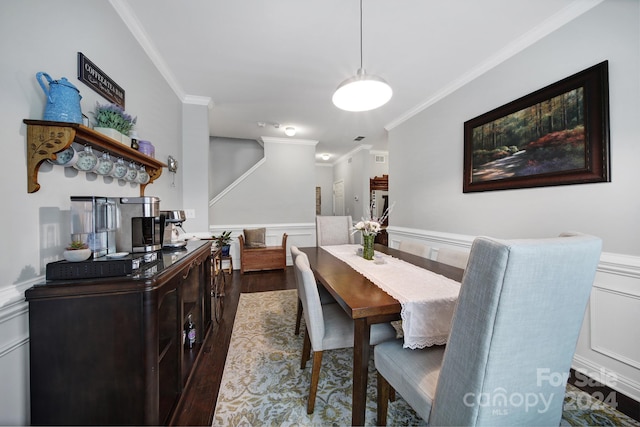 dining space with crown molding and dark hardwood / wood-style floors