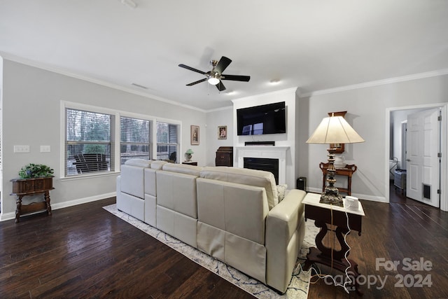 living room with ceiling fan, dark hardwood / wood-style flooring, and ornamental molding