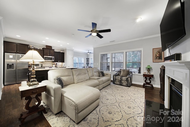 living room with light wood-type flooring, ceiling fan, and crown molding