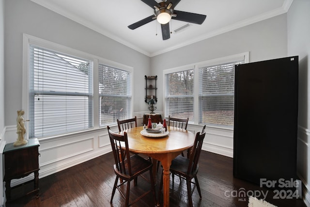 dining area featuring dark hardwood / wood-style flooring, plenty of natural light, and ornamental molding