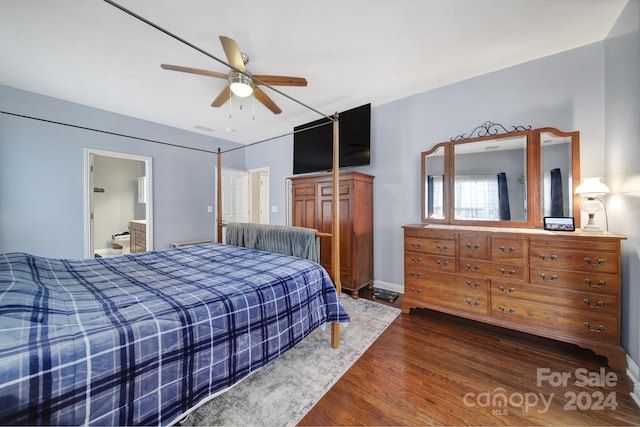 bedroom featuring ceiling fan, dark hardwood / wood-style floors, and connected bathroom