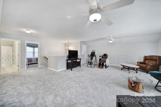 carpeted living room featuring ceiling fan with notable chandelier