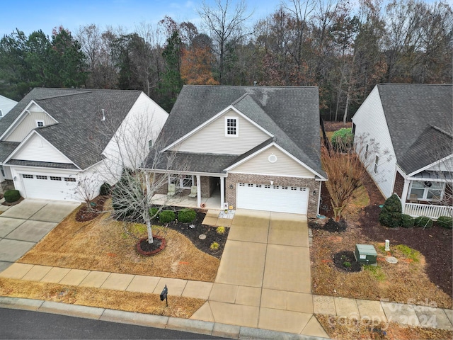 front of property featuring a porch and a garage