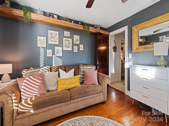 living room featuring ceiling fan and hardwood / wood-style floors