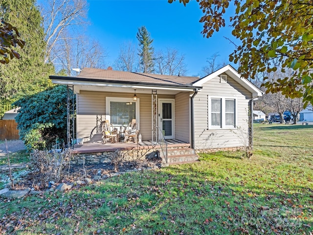 ranch-style home with covered porch and a front lawn