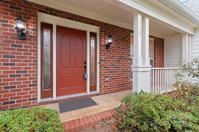 view of exterior entry featuring a porch