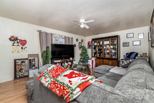 living room with wood-type flooring and ceiling fan