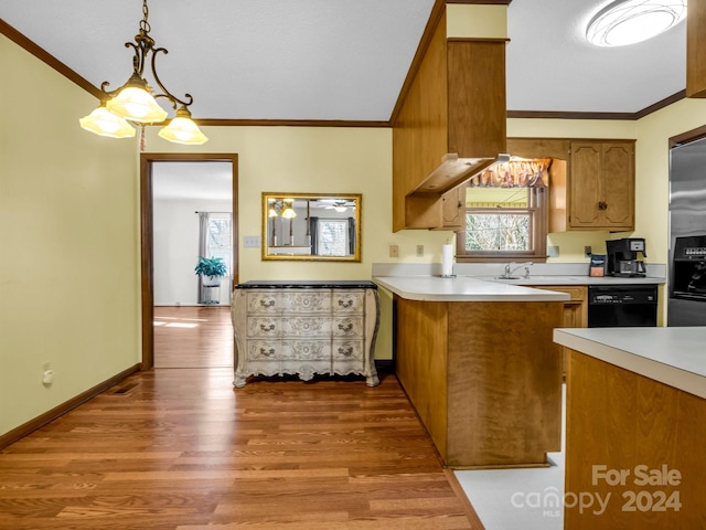 kitchen featuring dishwasher, kitchen peninsula, pendant lighting, light hardwood / wood-style floors, and ornamental molding