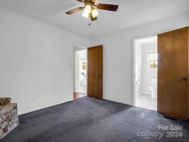 carpeted spare room with ceiling fan and ornamental molding