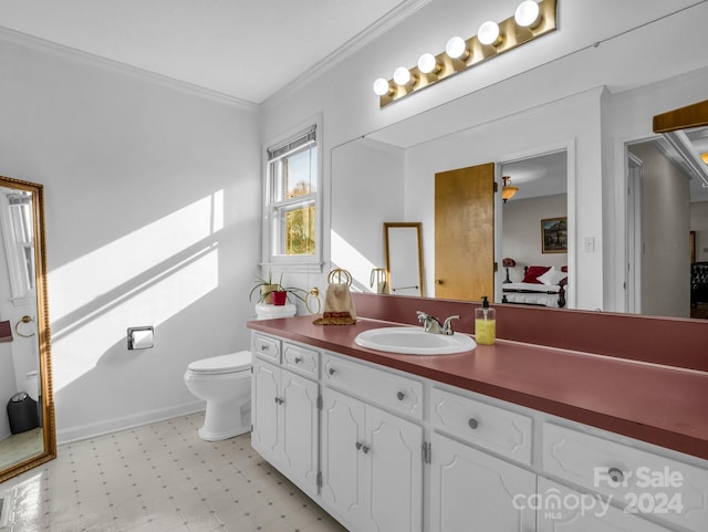 bathroom with vanity, toilet, and ornamental molding