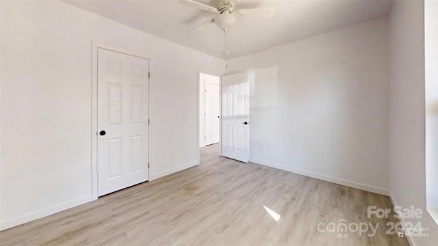 spare room featuring ceiling fan and light hardwood / wood-style flooring