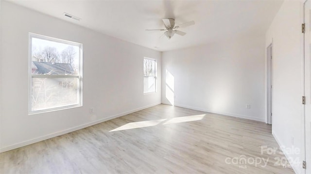 empty room featuring plenty of natural light and light hardwood / wood-style floors