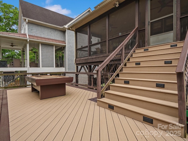 deck featuring stairs, ceiling fan, and a sunroom