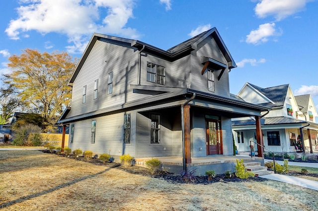 view of side of property with a porch