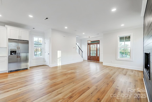 unfurnished living room featuring light hardwood / wood-style floors