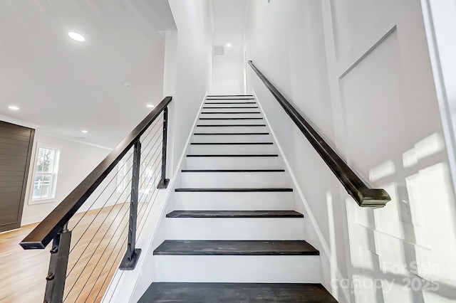 stairs with hardwood / wood-style floors