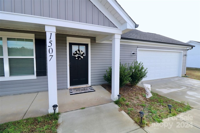 property entrance with a porch and a garage