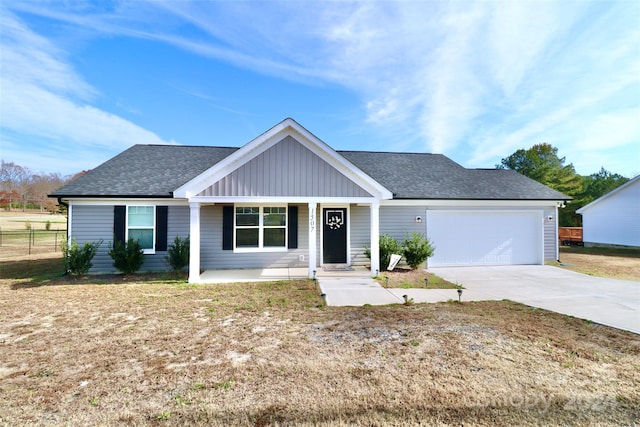 view of front of property with a porch and a garage