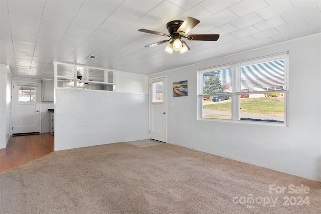 unfurnished living room with wood-type flooring, ceiling fan, and crown molding