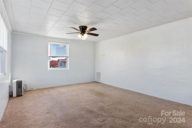 carpeted empty room featuring crown molding and ceiling fan