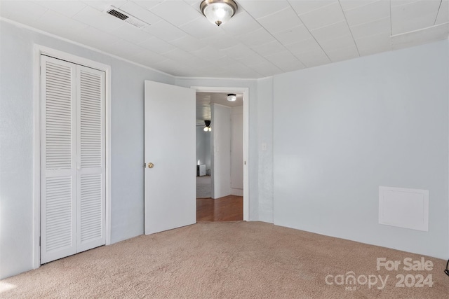 unfurnished bedroom featuring a closet and carpet