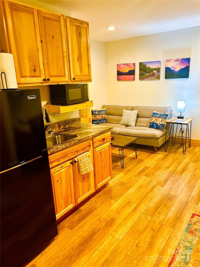 229 Seton Rd, Lake Lure, NC 28746 - kitchen with black appliances, light wood finished floors, dark stone countertops, recessed lighting, and open floor plan