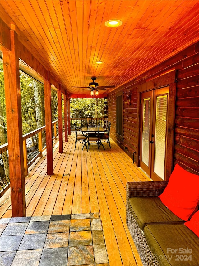 wooden deck featuring ceiling fan, french doors, and a porch