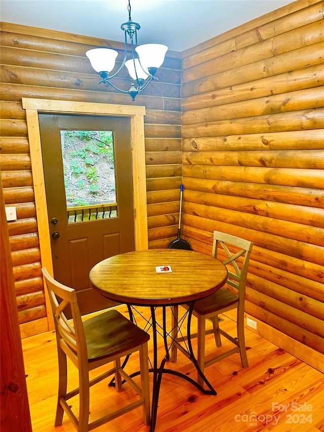 229 Seton Rd, Lake Lure, NC 28746 - dining area featuring rustic walls, wood finished floors, and a chandelier