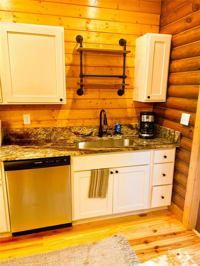 229 Seton Rd, Lake Lure, NC 28746 - kitchen featuring dishwasher, rustic walls, light wood finished floors, dark stone counters, and white cabinetry