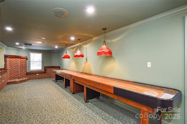 rec room featuring crown molding, carpet floors, and brick wall