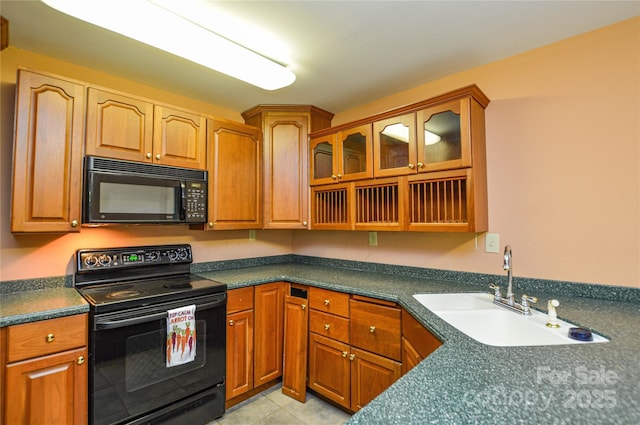 kitchen with sink, light tile patterned floors, and black appliances