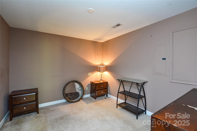 living area featuring light colored carpet and electric panel