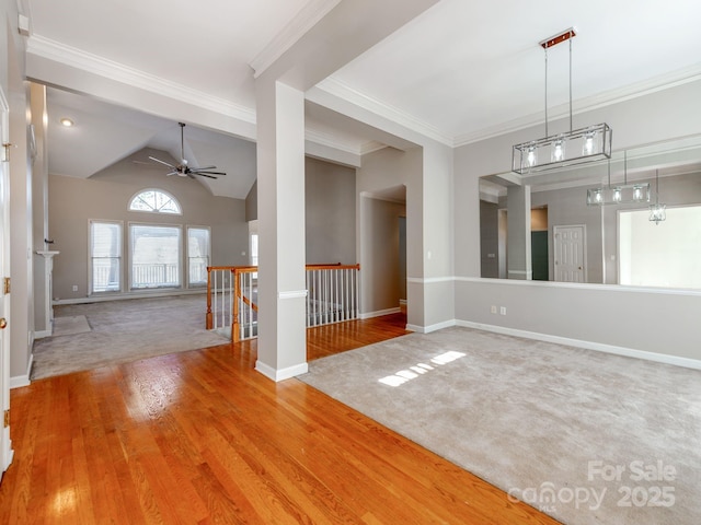 spare room with lofted ceiling, hardwood / wood-style floors, ceiling fan, and ornamental molding