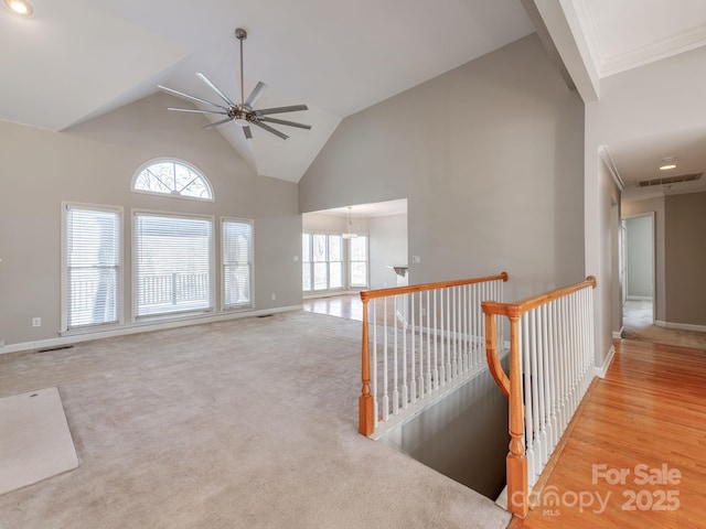 interior space with light carpet and lofted ceiling