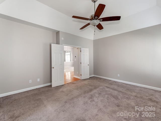 unfurnished bedroom featuring lofted ceiling, carpet floors, and ceiling fan