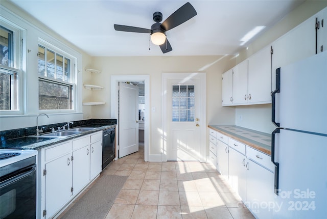 kitchen with white appliances, sink, ceiling fan, light tile patterned floors, and white cabinetry