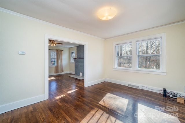 spare room with dark hardwood / wood-style floors, plenty of natural light, ornamental molding, and ceiling fan