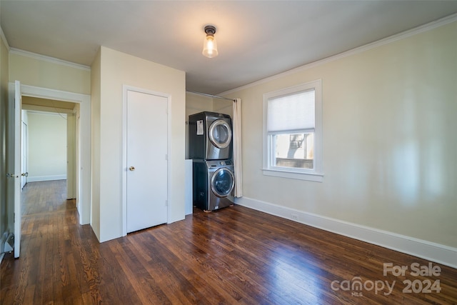 laundry area with dark hardwood / wood-style flooring, stacked washing maching and dryer, and ornamental molding