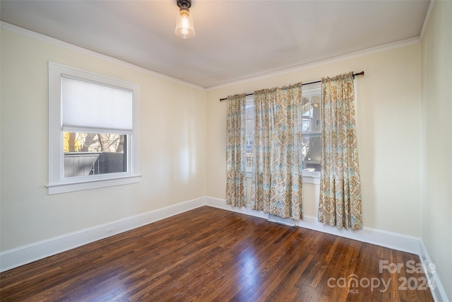 empty room with crown molding and dark hardwood / wood-style floors